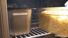 a container of cheese sits on a shelf in a refrigerator with a label that says made in animotica