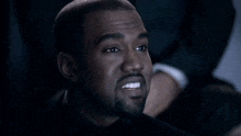 a close up of a man 's face with a smile on his face