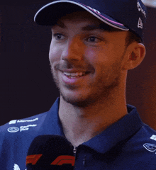 a man wearing a hat and a blue shirt with the word ahh on it