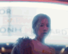 a blurry picture of a woman standing in front of a sign that says onh