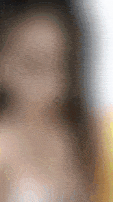 a blurry picture of a person 's face with a small diamond in the middle