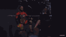 a wrestler in a walking weapon outfit is being photographed by a cameraman