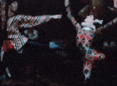 a man and a woman are dancing in front of a crowd of people .