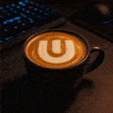 a cup of cappuccino with a letter u on it