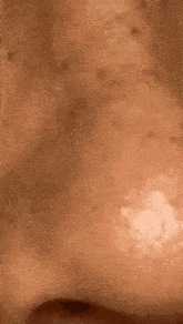 a close up of a person 's face with a white spot on it