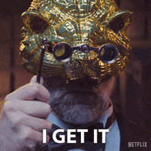 a man wearing a mask and glasses says i get it on the bottom