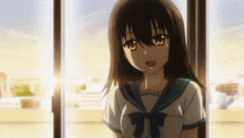 a girl with long black hair and yellow eyes is standing in front of a window