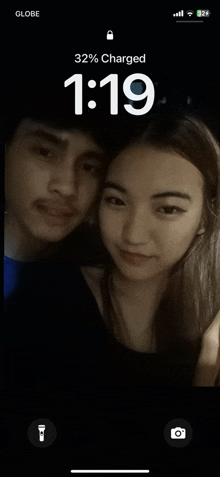 a phone screen shows a picture of a man and a woman and says 32 % charged at 1:19