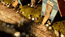 a cartoon house is sitting on top of a rocky hillside .