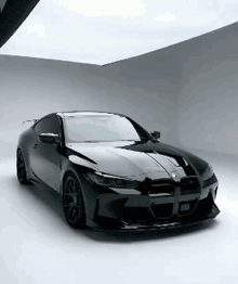 a black bmw is parked on a white floor