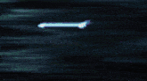 a purple and white light is coming out of a black background