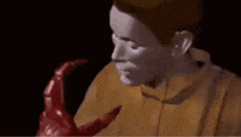 a man is holding a red monster in his arms in a cartoon .
