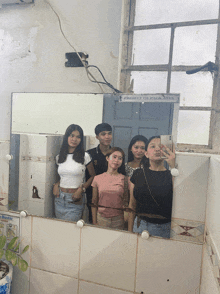a group of people are taking a selfie in front of a mirror that says project of cica 2013