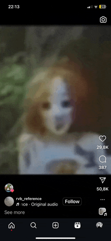 a blurred image of a girl with a mask on her face is displayed on a phone screen