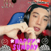 a man wearing headphones is making a heart shape with his hands and the words happy sunday behind him