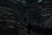 a man and a woman are standing in front of a waterfall in a video game