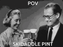 a man and a woman are toasting with beer .
