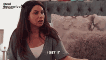 a woman says i get it in front of a real housewives ad
