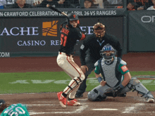 a baseball game is being played in front of an advertisement for ache casino resort