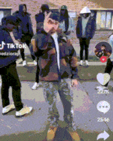 a group of people are standing in front of a building with a tiktok logo on the bottom