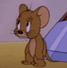 jerry from tom and jerry is sitting in front of a tent .