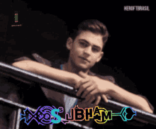a man leaning on a railing with the word jbhm on the bottom right