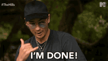 a man wearing sunglasses and a black hat says i 'm done