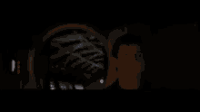 a blurred image of a person standing in a dark room .
