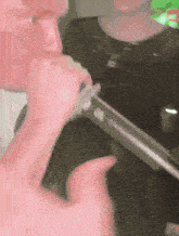 a close up of a person drinking from a straw that says ' coca cola ' on it