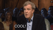 a man in front of a crowd says cool anyway