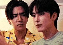 two young men are standing next to each other and one of them is wearing a shirt that says ' aloha '