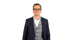 a man in a suit and vest is making an ok sign