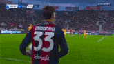 a man without a shirt is running on a soccer field in front of a betway sign