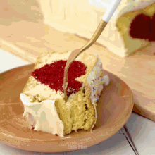 a slice of cake with a heart shaped filling is on a plate