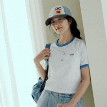 a woman wearing a kodak hat and a white shirt