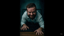 a man with a beard is crawling out of a laptop screen