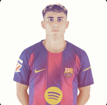 a young man wearing a purple and red nike shirt with amblic on the sleeve