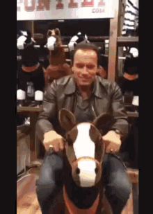 Horsing Around At Cowboy Christmas GIF - Arnold Schwarzenegger Horse Toy GIFs