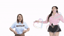 two women are standing next to each other and one is wearing a shirt that says " loading "