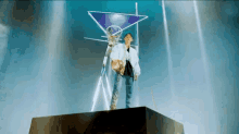 a man in a white jacket is standing on top of a pyramid holding a basketball