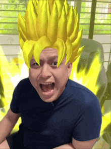 a man in a blue shirt has a yellow wig on his face