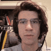 a young man wearing glasses and headphones is taking a selfie with pixiz