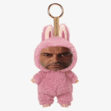 a man in a pink bunny costume is surrounded by butterflies and a key chain that says the monsters