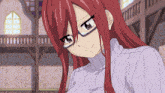 a girl with red hair and glasses is wearing a sweater