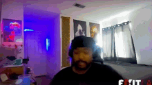 a man wearing headphones stands in a room with a sign that says exit