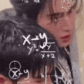 a man and a woman are looking at a chalkboard with math equations on it
