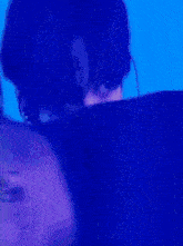 a close up of a person 's face in front of a blue wall .