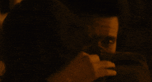 a close up of a person 's face with a dark background