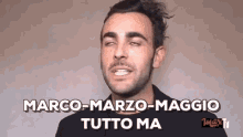 a man with a beard is making a funny face with his eyes closed and the words marco-marzo-maggio tutto ma .