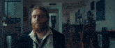 a man with a beard wearing a suit and tie